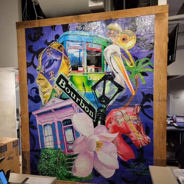 Colorful Creole 2 Geaux mural with a streetcar, Bourbon Street sign, pelican, and magnolia flower.